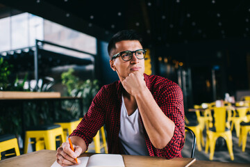 Man thinking and making notes