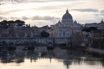 Fototapeta na wymiar Sunset view on river tiber with St. Peter Basilic in Rome, Italy