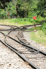 Obraz premium Empty railway switch crossing point inside forest. Selective focus.