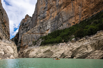 Fototapeta na wymiar Congost de Mont Rebei, mountain gorge with azure river and canoe, kayaking in Aragon, Catalonia, Spain