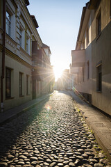 Fototapeta na wymiar Vilnius old town street with paving stones in sunset