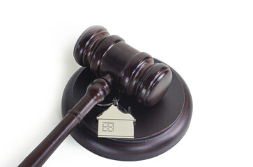 Abstract photo with wooden gavel and abstract house isolated on white background