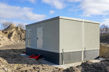 Unfinished modern large outdoor electric high voltage distribution box in a new industrial facility