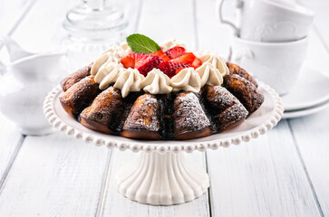 Traditional German strawberry cheese cake with fresh fruits and white chocolate cream served as close-up on a cake plate