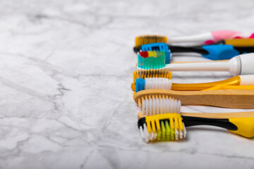 Electric, bamboo and ordinary toothbrushes on a colored background. Oral hygiene. Eco. Prevention...