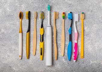 Electric, bamboo and ordinary toothbrushes on a colored background. Oral hygiene. Eco. Prevention of caries. Dental car. The concept of dentistry and eco-friendly lifestyle.Place for text.