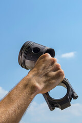the craftsman's holds a connecting rod with a piston