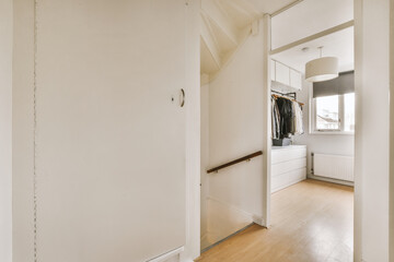 the inside of a house with wood flooring and white walls, including an open door that leads to...