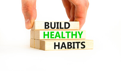 Motivation and Build healthy habits symbol. Concept words Build healthy habits on wooden block on a beautiful white table white background. Business build healthy habits concept. Copy space.