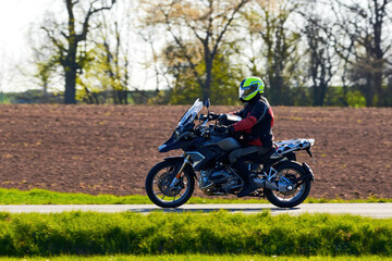 Fototapeta na wymiar Unidentified man with helmet riding a motorcycle