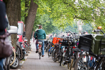 Naklejka premium biker surounded by parked bicicles