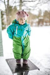 A little girl in the harsh northern winter