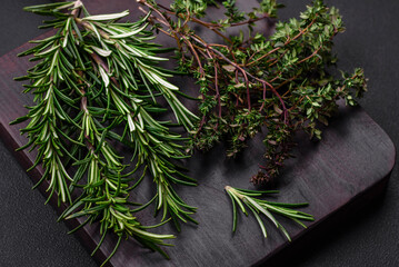 Sprigs of fresh green rosemary on a wooden cutting board