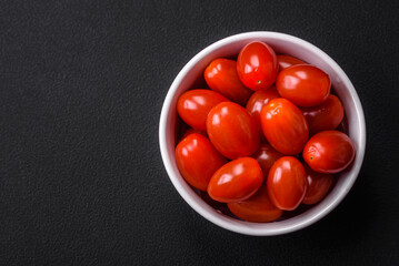 Fresh tasty cherry tomatoes in a white ribbed bowl