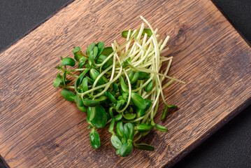 Fresh sprouts or sunflower microgreens on wooden cutting board