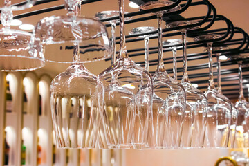 close-up of wine glasses hanging in a restaurant, suspended