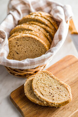 Sliced whole grain bread. Tasty wholegrain pastry with seeds on cutting board.