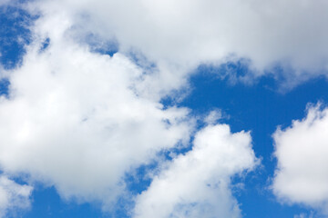 Sunny background with blue sky and white clouds as summer natural background.