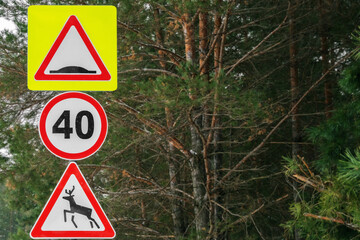warning road signs in the forest park area, warning sign about animals in the forest, speed limit warning sign