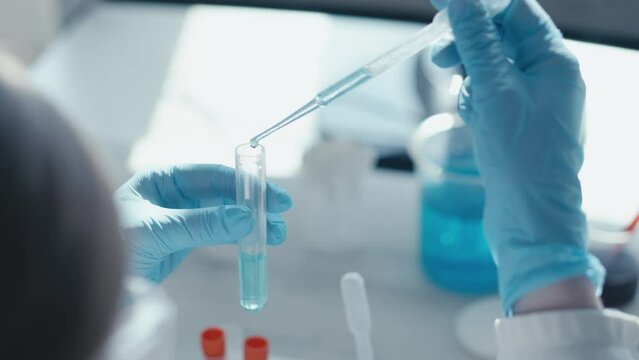 Medical research laboratory. A scientist works with a pipette and a test tube. Scientific laboratory of biotechnology, development of medicine and research in chemistry, biochemistry and experiments.