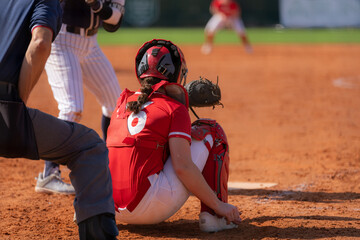 Fastpitch softball catcher waiting for pitch with batter.
