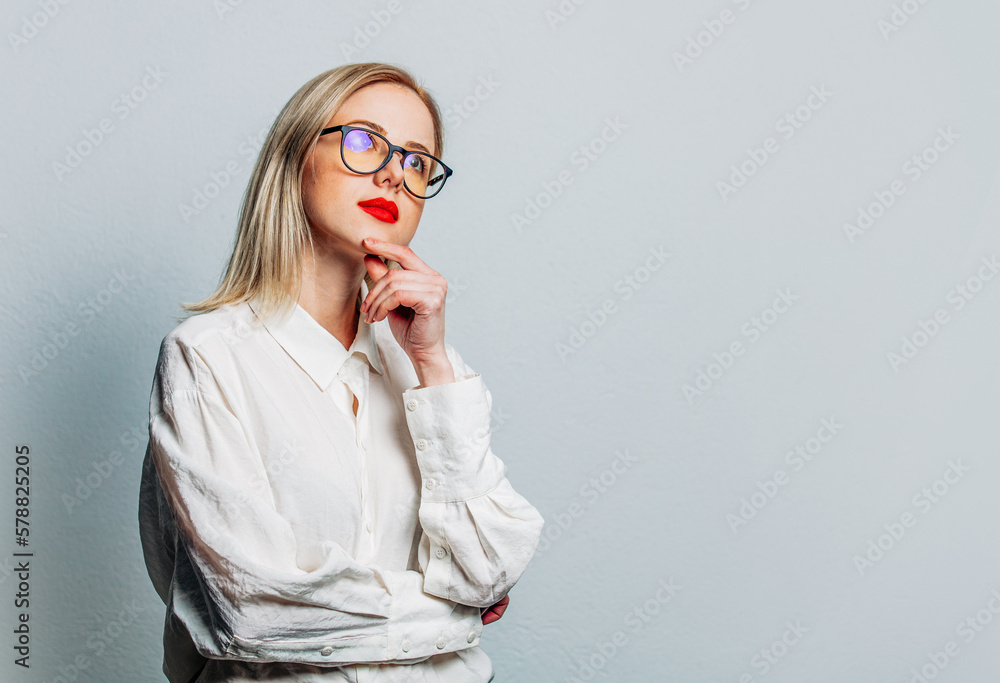 Wall mural blonde in glasses and white shirt on white background