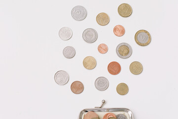 Open wallet with different coins isolated on white background top view. Financial crisis, poverty, lack of money concept