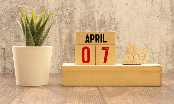 7 April on wooden grey cubes. Calendar cube date 07 April. Concept of date.