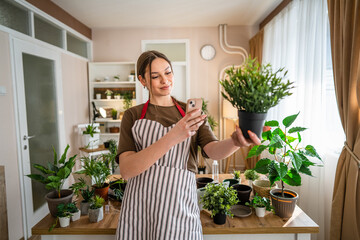 One young woman take care of plant and photos with her smartphone