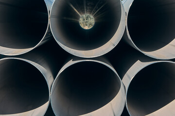 Close-up of the ends of stainless steel pipes, pipes for the food industry are stored outdoors,...