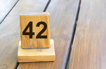 Wooden priority number 42 on a plank tab
