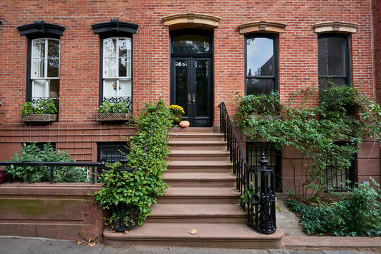 a view of a row of historic brownstones in an iconic neighborhood of Manhattan, New York City