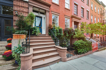 Fototapeta na wymiar a row of brownstone buildings on an iconic street of Manhattan, New York City.