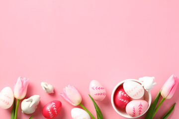 Happy Easter greeting card design. Easter eggs and tulips on pastel pink background. Flat lay, top view, overhead.