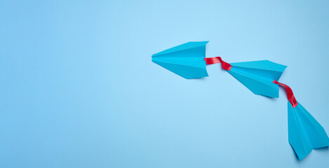 A group of blue airplanes follows each other, a concept of mass influence and manipulation