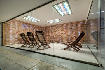 interior of modern wellness salt haloper cave with uv light with wooden bench