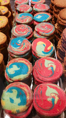 Fototapeta na wymiar Rainbow colored cookies on display in local bakery in Germany. Red Dye 40 was found to be not safe.