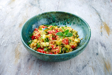 Traditional Moroccan vegetable couscous with zucchini and paprika served as close-up on a Nordic Design bowl with copy space - obrazy, fototapety, plakaty