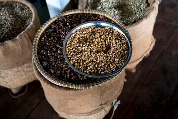 Coffee beans in a bamboo basket in close-up view.