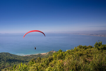 Da Nang city, Quang Nam province, Vietnam - June 25, 2017: flying paragliding on top of Son Tra Mountain. This is a regular activity of parachute flying club
