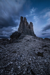 Torri del Vajolet mountain range in Trentino, Italy at sunset over a cloudy sky