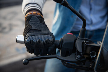 Close-up of an african biker's hand holding the handlebars of his motorcycle