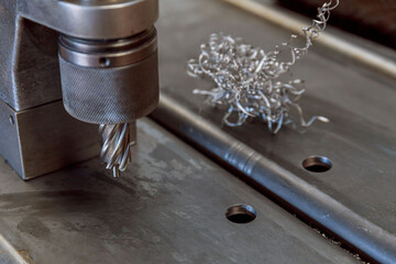 Portable magnetic drill. Portable mag drill makes deep holes in solid steel or plates. Metal shavings