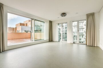 an empty living room with sliding glass doors that open to the outside, and there is no one in sight