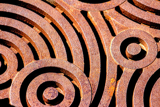 Beautiful, Artistic, Rusty Metal or Iron Grate with Swirls & Circles for a Background, Backdrop or Wallpaper