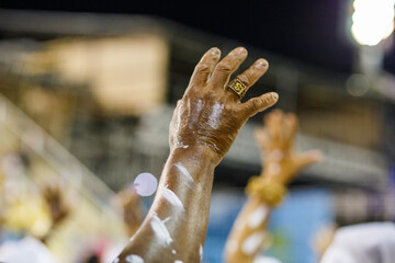 black arm outdoors during carnival rehearsal in Rio de Janeiro.