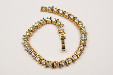 Old accent gold bracelet, unique vintage rhinestone jewelry background	