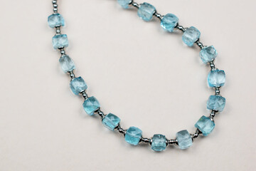 Colorful gemstone crystal beads necklace on white, unique handmade jewelry background