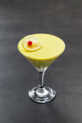 Lemon cream jelly, Panna Cotta in a martini glass. Dark background
