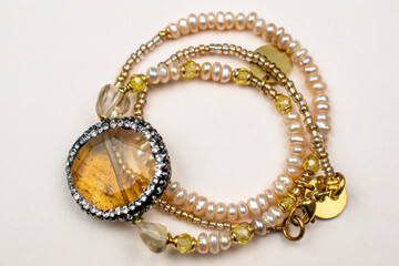 Obraz premium Colorful gemstone crystal beads necklace on white, unique handmade jewelry background
